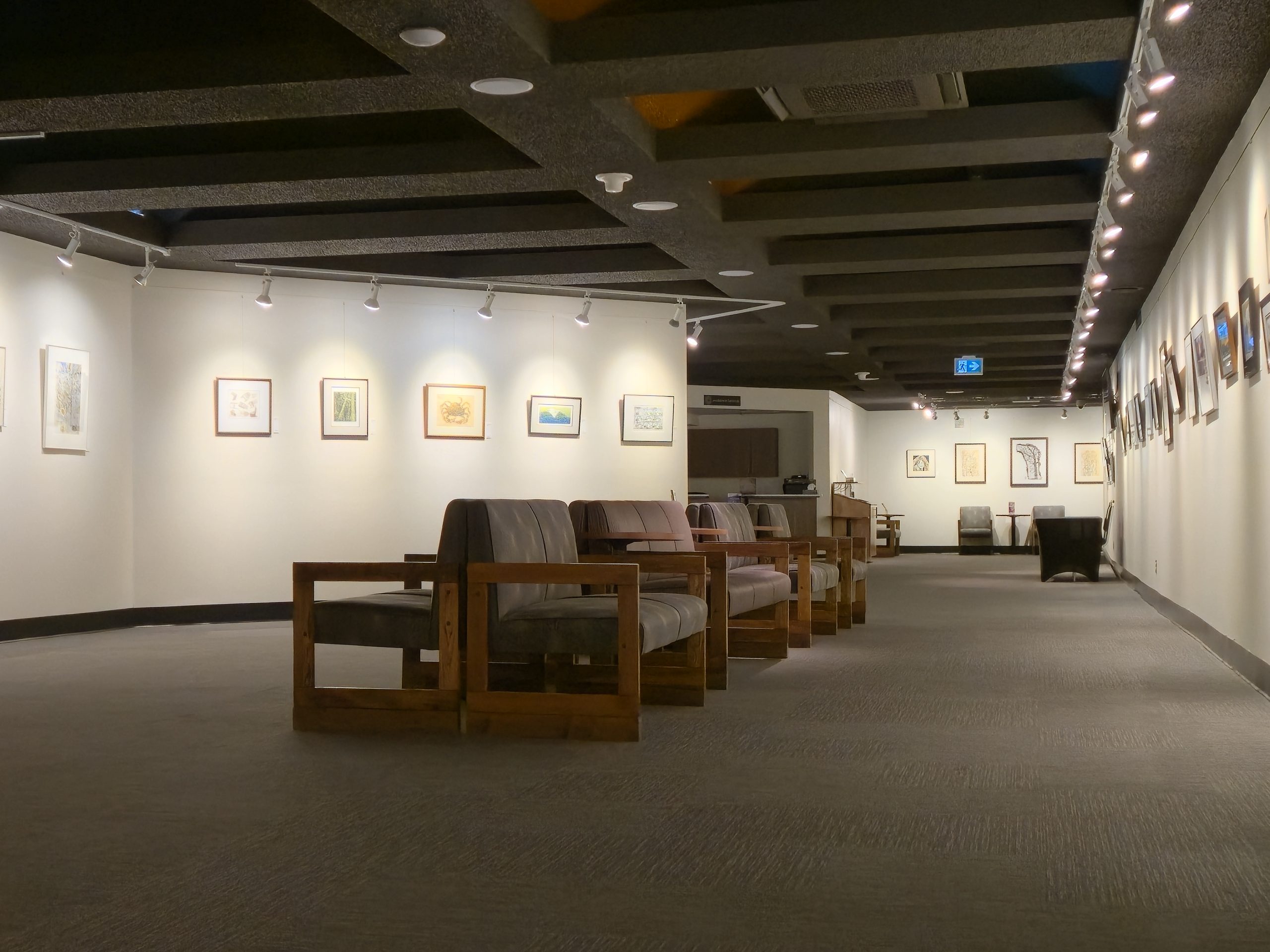 Photo of the totem pole in the Cowichan Performing Arts Centre lobby staircase